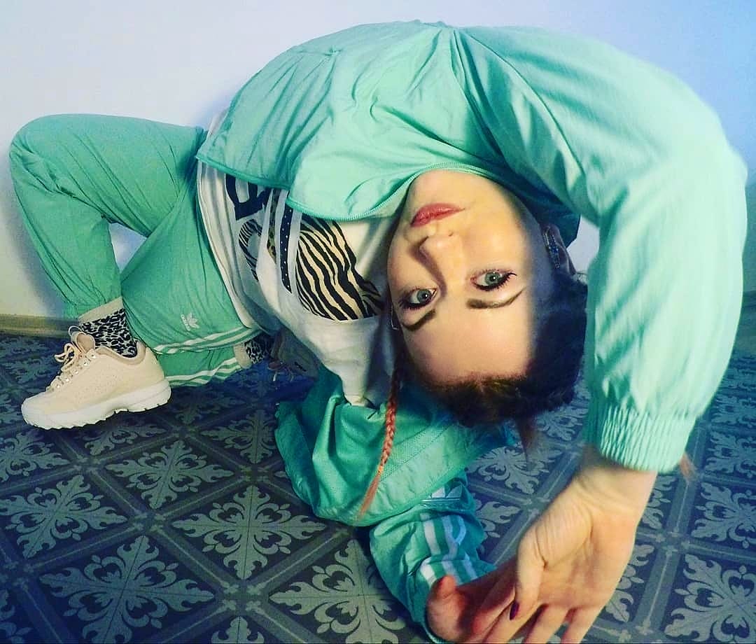 Graduate Annette Olsen posing in a backbend on a patterned floor